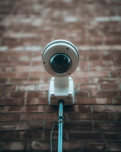 Dome security camera mounted on a brick wall